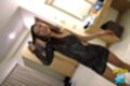 Playing with her hair wearing sheer black dress