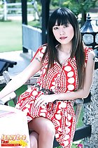 Seated in red dress legs crossed long hair