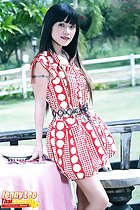Jenny Lee standing beside table wearing dress