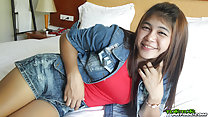 Tan lying on bed in denim shorts